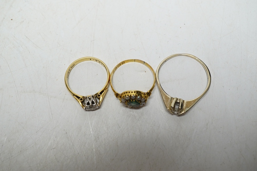 An 18ct gold illusion set solitaire diamond ring, size L, 3 grams, an 18ct gold pearl and green stone cluster ring, size L, 1.8 grams, and a white gold? solitaire diamond ring, size U, 2.9 grams. Condition - pearl and gr